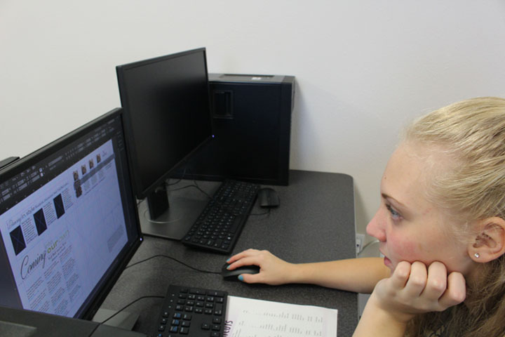 Freshman Jordan Lichtner works on a Yearbook spread for the first deadline in October. The first Yearbook class had almost no prior experience designing.