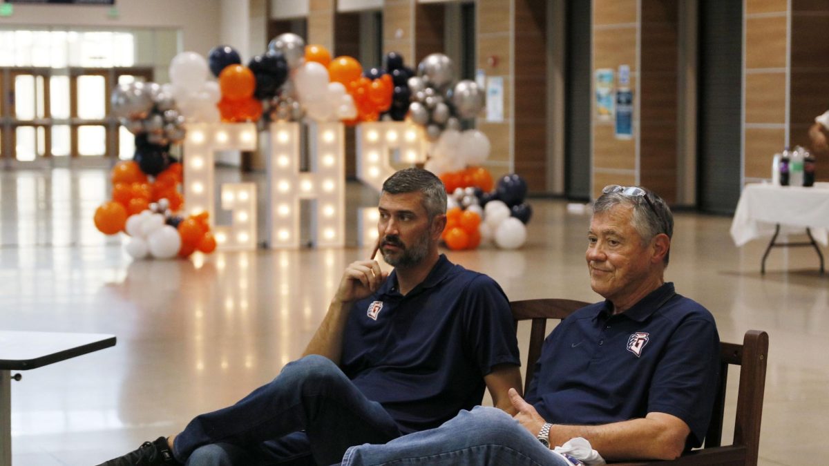 New principal Josh Haug, left, sits next to the school's namesake Tom Glenn at the senior dinner on Sept. 21. 