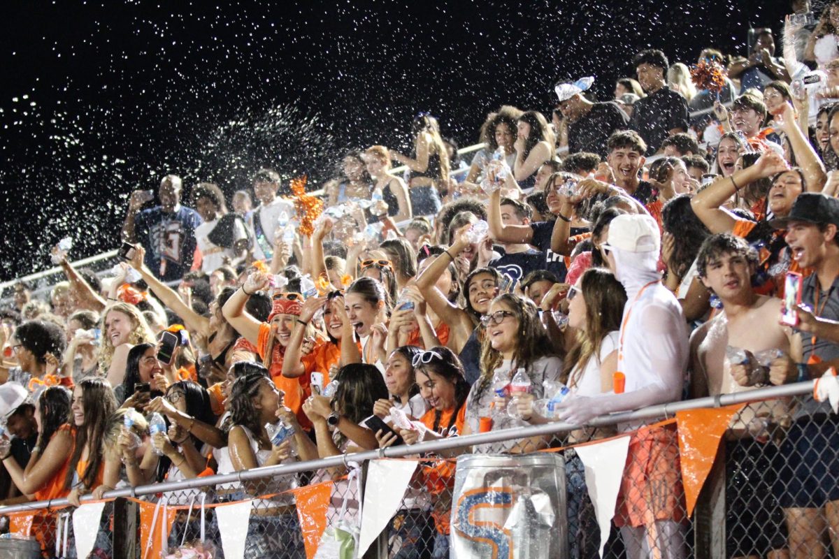 The student section goes wild with water bottles after halftime at the HOCO game against Georgetown Eastview on Sept. 26.