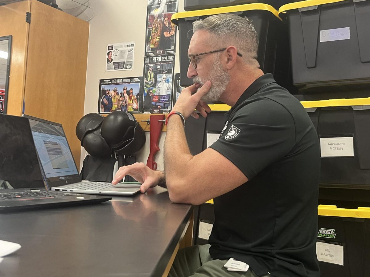 Law and Investigations teacher Jeffrey Schiller works on his book.