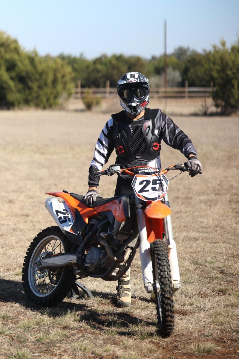 Senior Najib Louazna poses next to his dirtbike at his family farm.